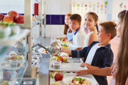 Children wait in line for a healthy school meal. In California, synthetic food dyes could soon be banned from foods sold in schools